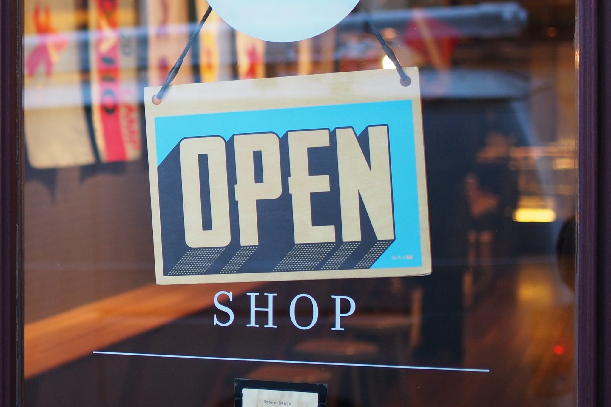 Open sign in window of dog store