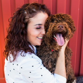 smiling woman hugging happy dog | the dog guide san antonio events